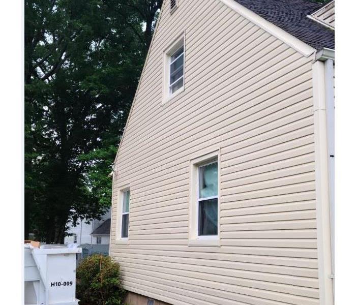 The same siding in the Before Photo is free of mold and stains from the basement to the attic