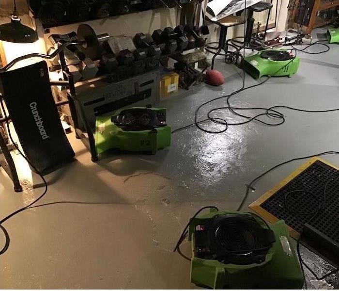 At least five SERVPRO air movers are set up to circulate air for drying throughout the property
