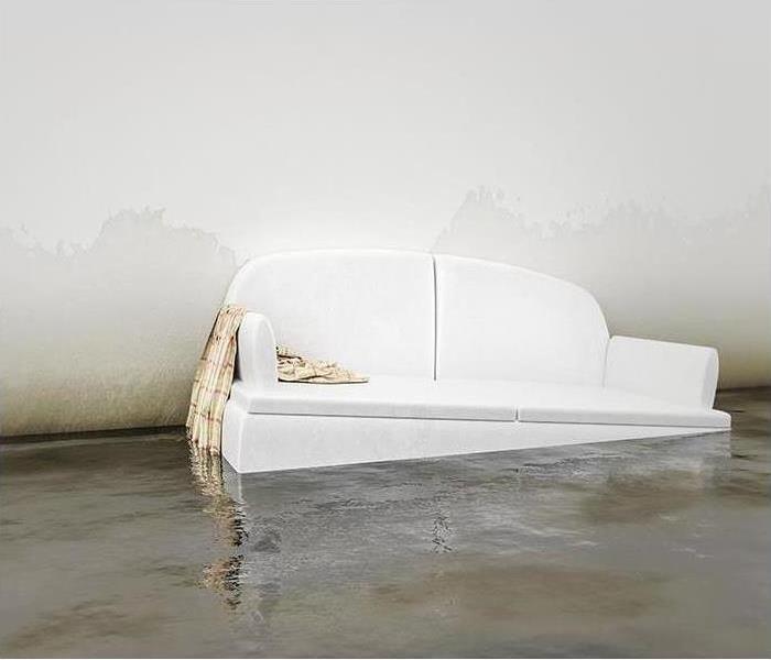 WHITE SOFA FLOATING IN A FLOODED ROOM
