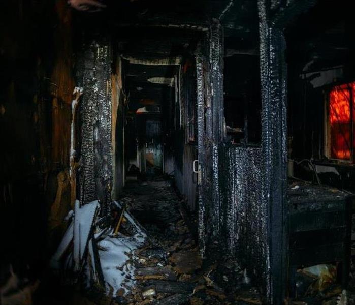 Dark burnt wooden house corridor after fire