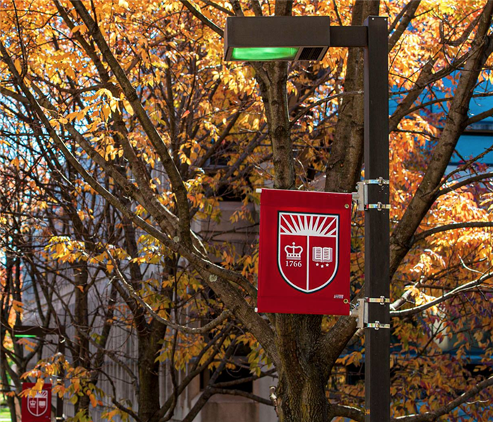 Fall leaves with a university sign. 